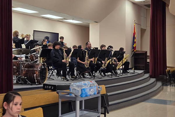 A middle school jazz band performs on stage